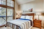 Master bedroom offers a queen bed and patio off to the side